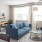 a living room with a blue couch and a table