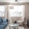 a living room with a blue couch and a television