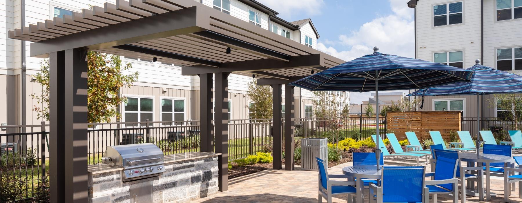 a patio with tables and chairs and umbrellas