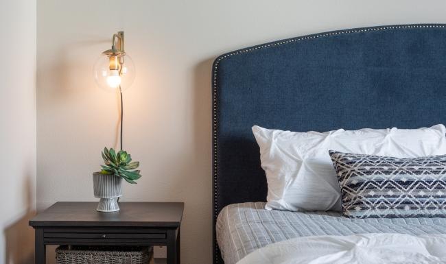 a bed with a blue pillow