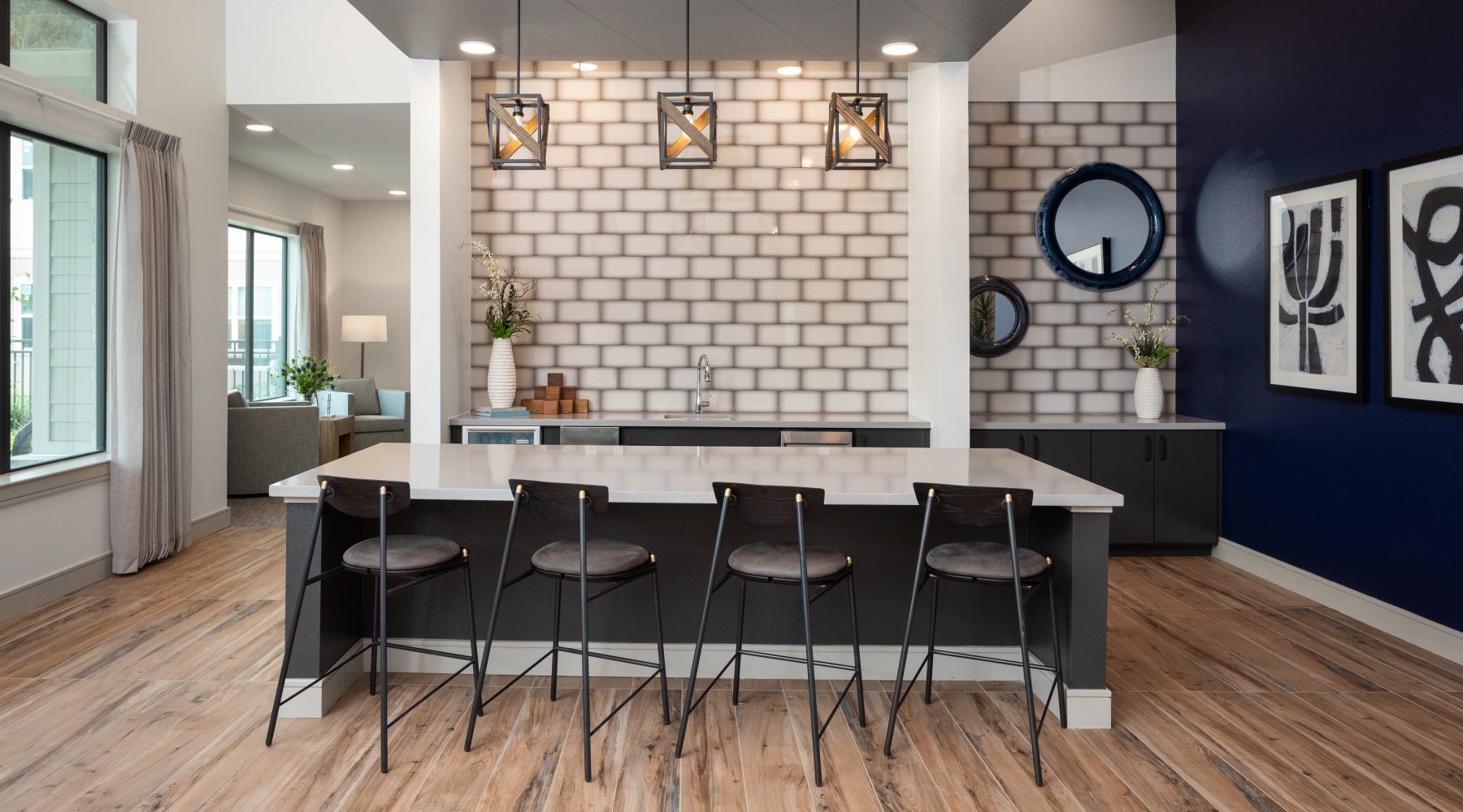 Clubhouse with large windows, modern furniture and kitchen