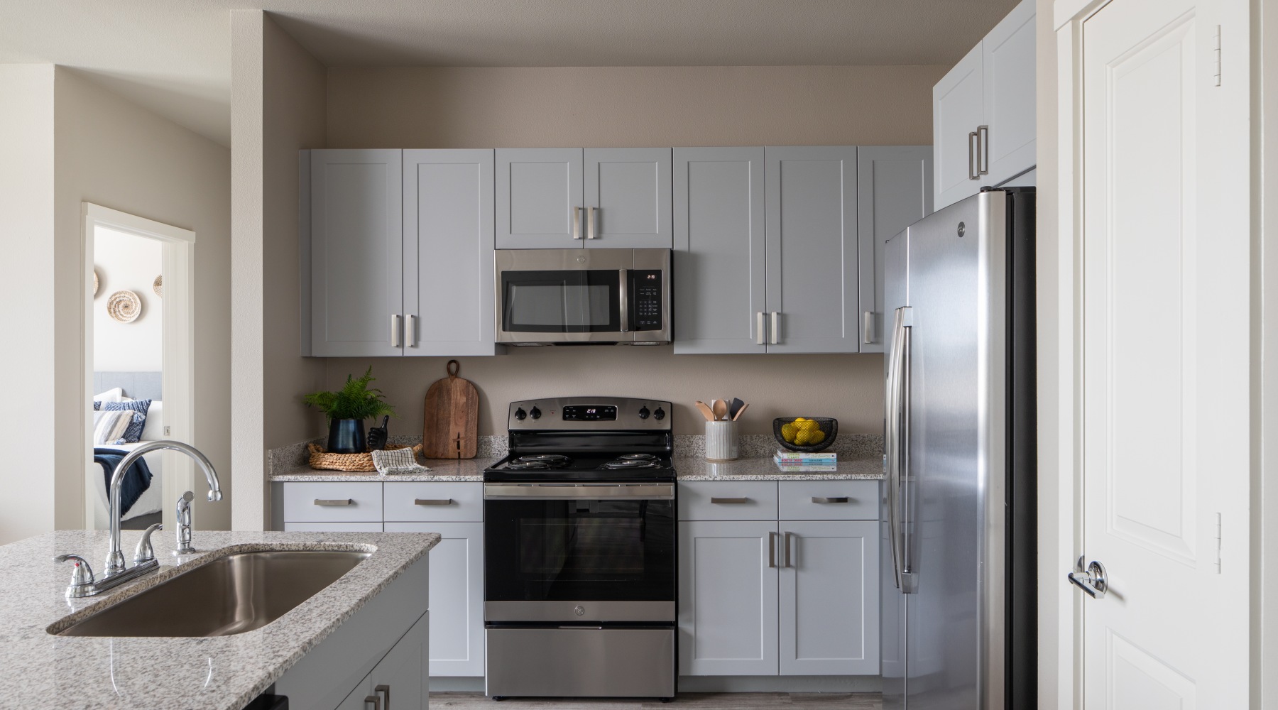a kitchen with gray cabinets