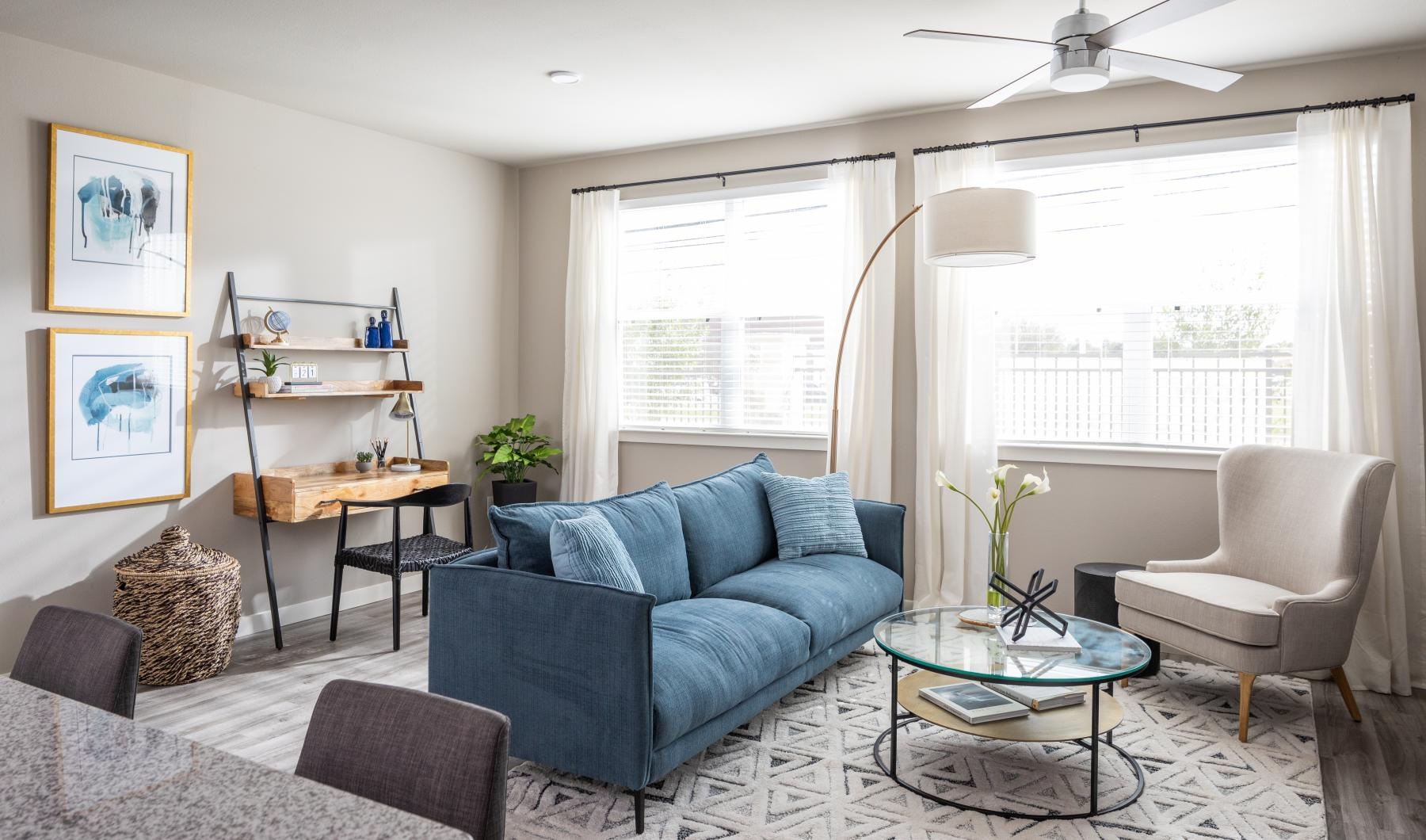 a living room with a blue couch and a table