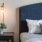 a bed with a blue pillow