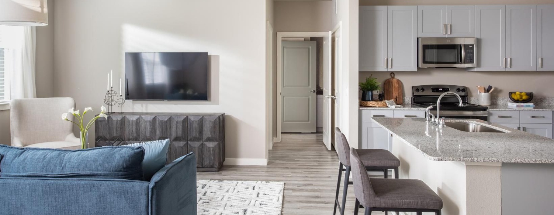a kitchen with a couch and a tv